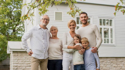 Family together in front of home